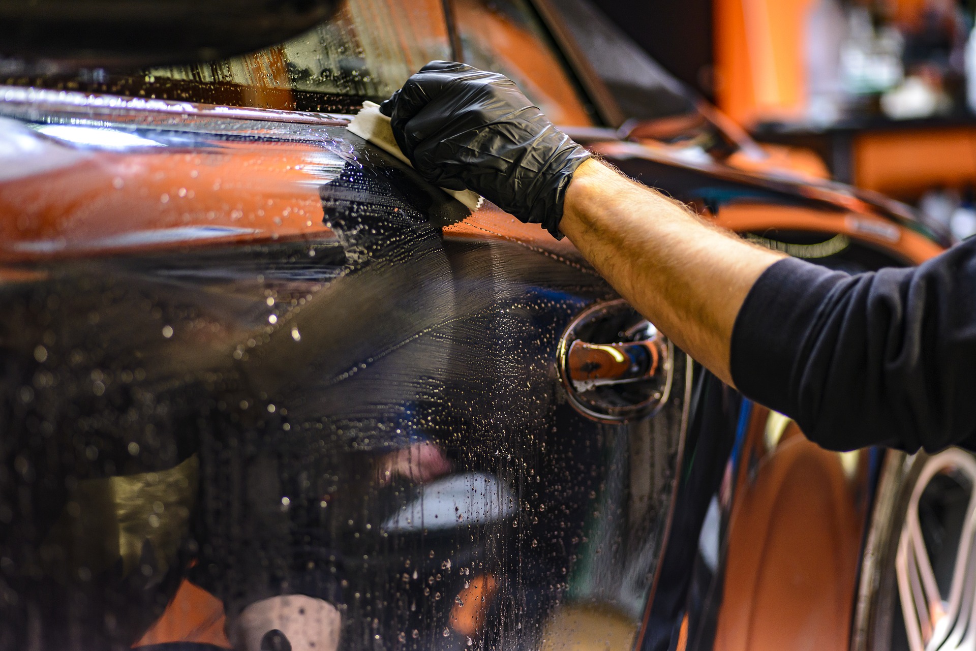 Hand waxing a black car Decatur Autowash best touchfree wash